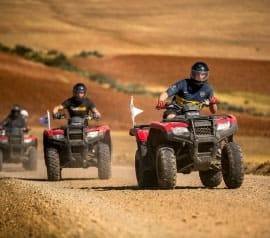 ATV tour Cusco with travelers riding quad bikes through Maras and Moray trails