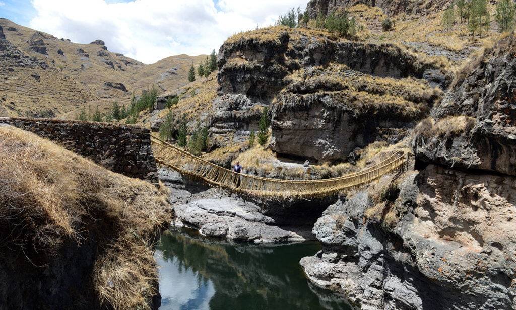 Q’eswachaka Inca Bridge spanning a canyon with calm waters