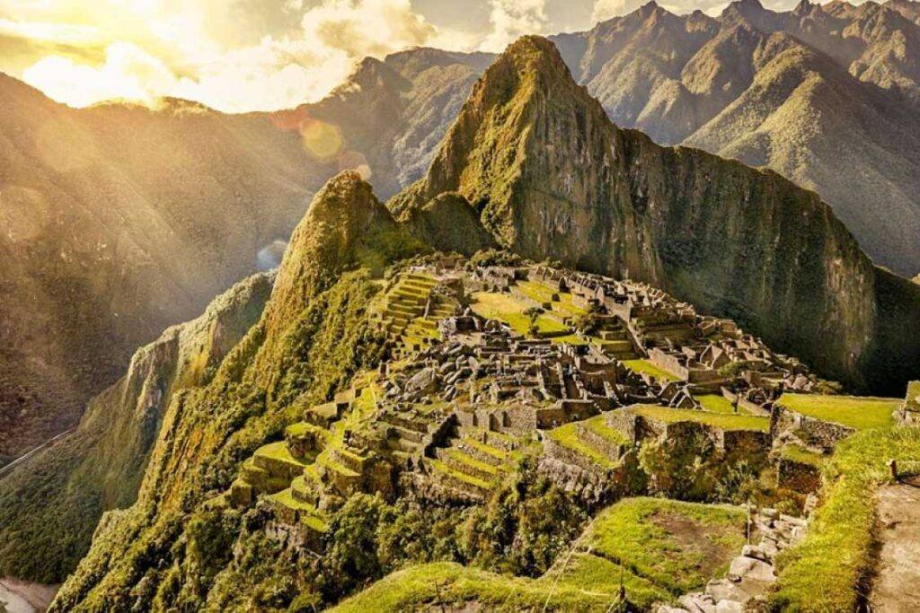 Machu Picchu – Andean Top panoramic view at sunrise with mountains and Inca terraces