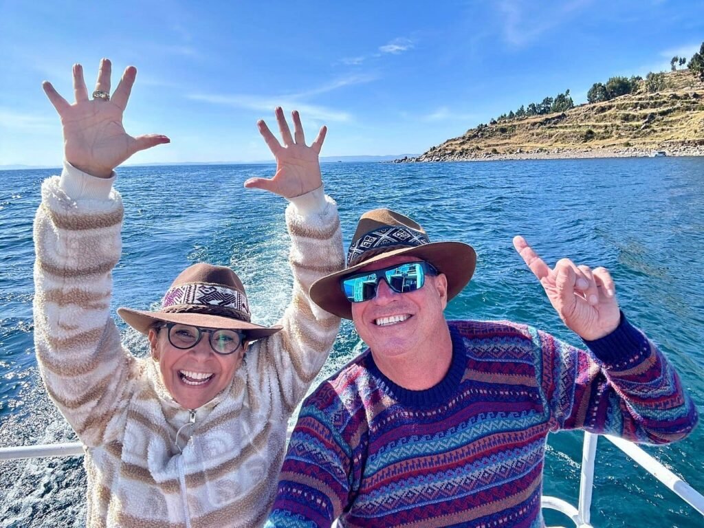 Lake Titicaca tour Puno – travelers enjoying a boat ride under the sun